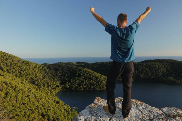 Happy,Man,Standing,On,A,Viewpoint,With,Raised,Arms,To