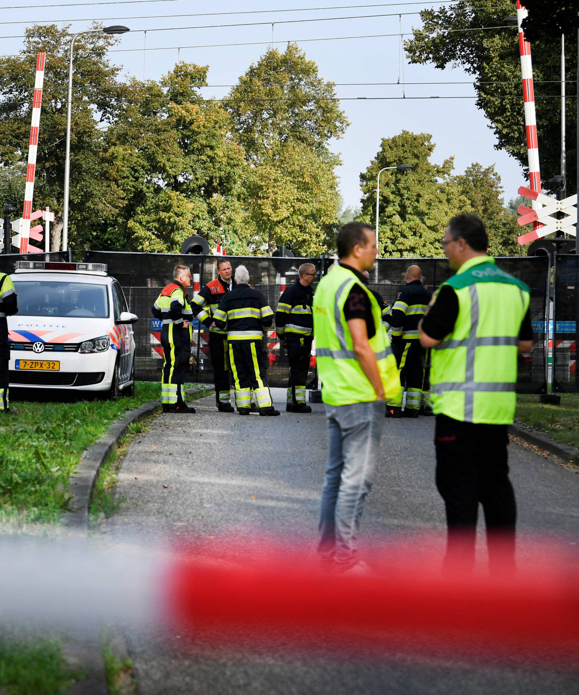 Rescue personnel work at the scene where a train struck a "cargo bicycle" popular with Dutch parents to transport their children at the city of Oss
