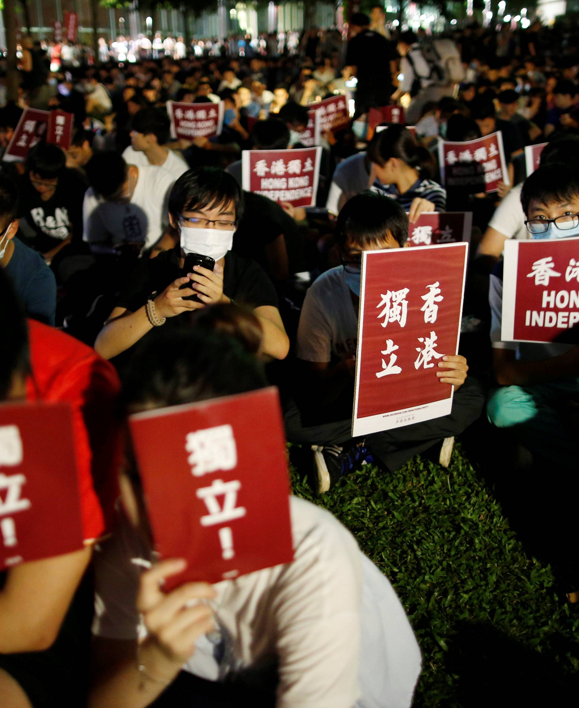 Protesters hold placards during a rally in support of independence advocates who have been barred from the Legislative Council elections in Hong Kong