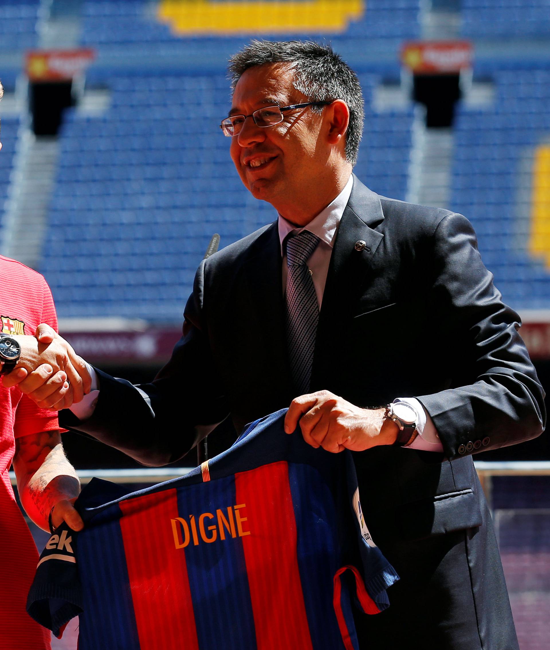 FC Barcelona's president Josep Maria Bartomeu poses with newly signed soccer player Lucas Digne during his presentation at Camp Nou stadium in Barcelona