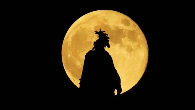 Full moon, known as the Hunter's moon, rises over the Statue of Freedom, in Washington