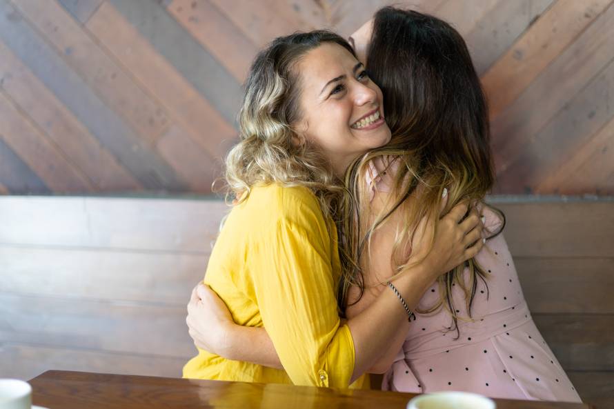 Pretty blond woman excited to see her long-distance friend