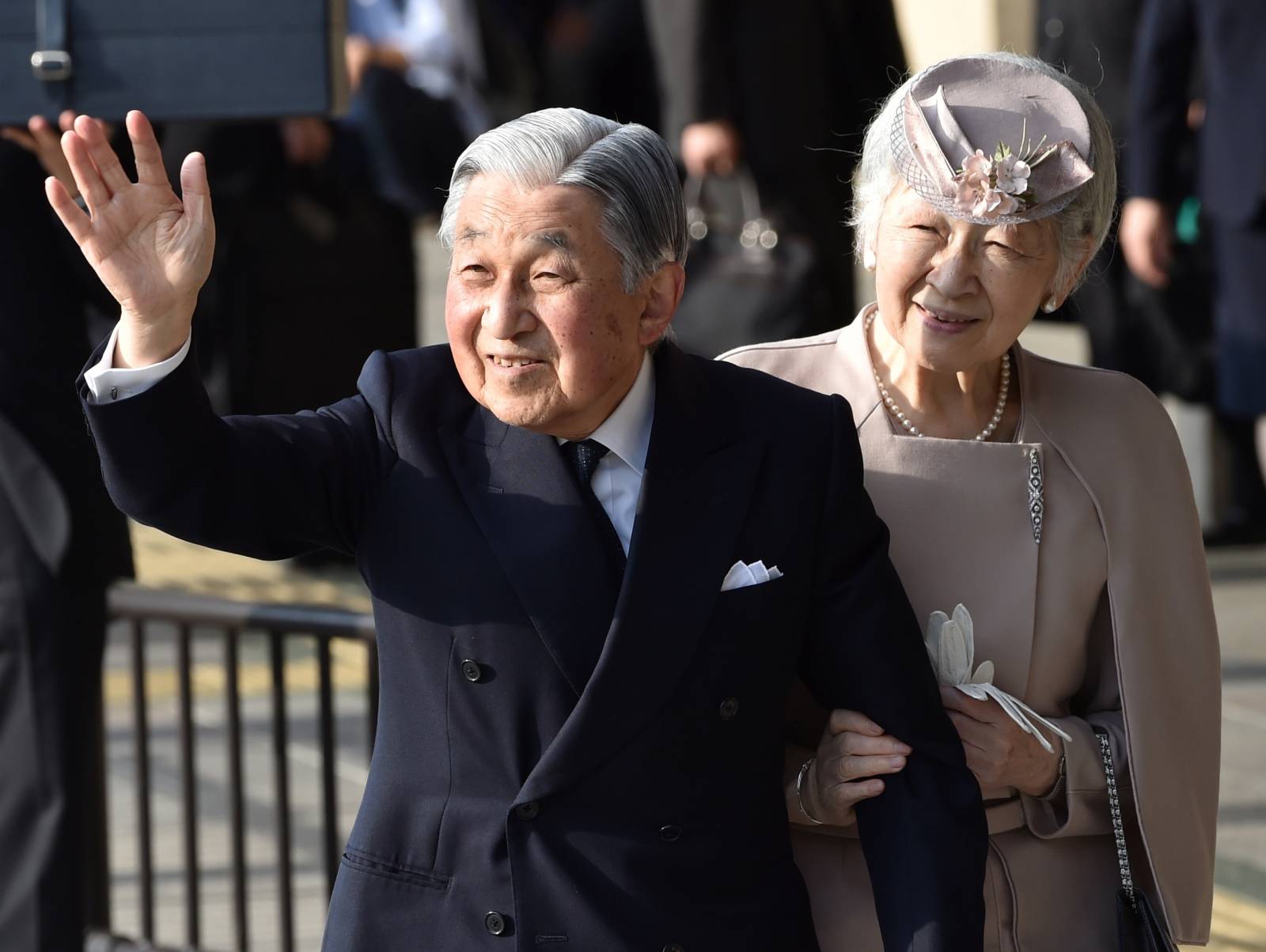 Japan's Emperor Akihito, accompanied by Empress Michiko, waves to well-wishers before leaving Ujiyamada Station after their visit to Ise Jingu shrine in Ise, Japan