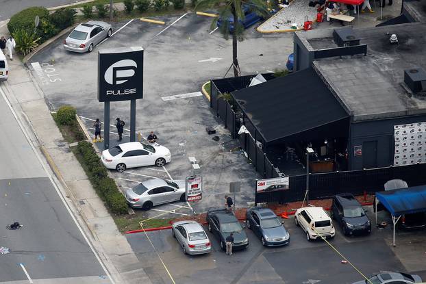 Investigators work the scene following a mass shooting at the Pulse gay nightclub in Orlando Florida