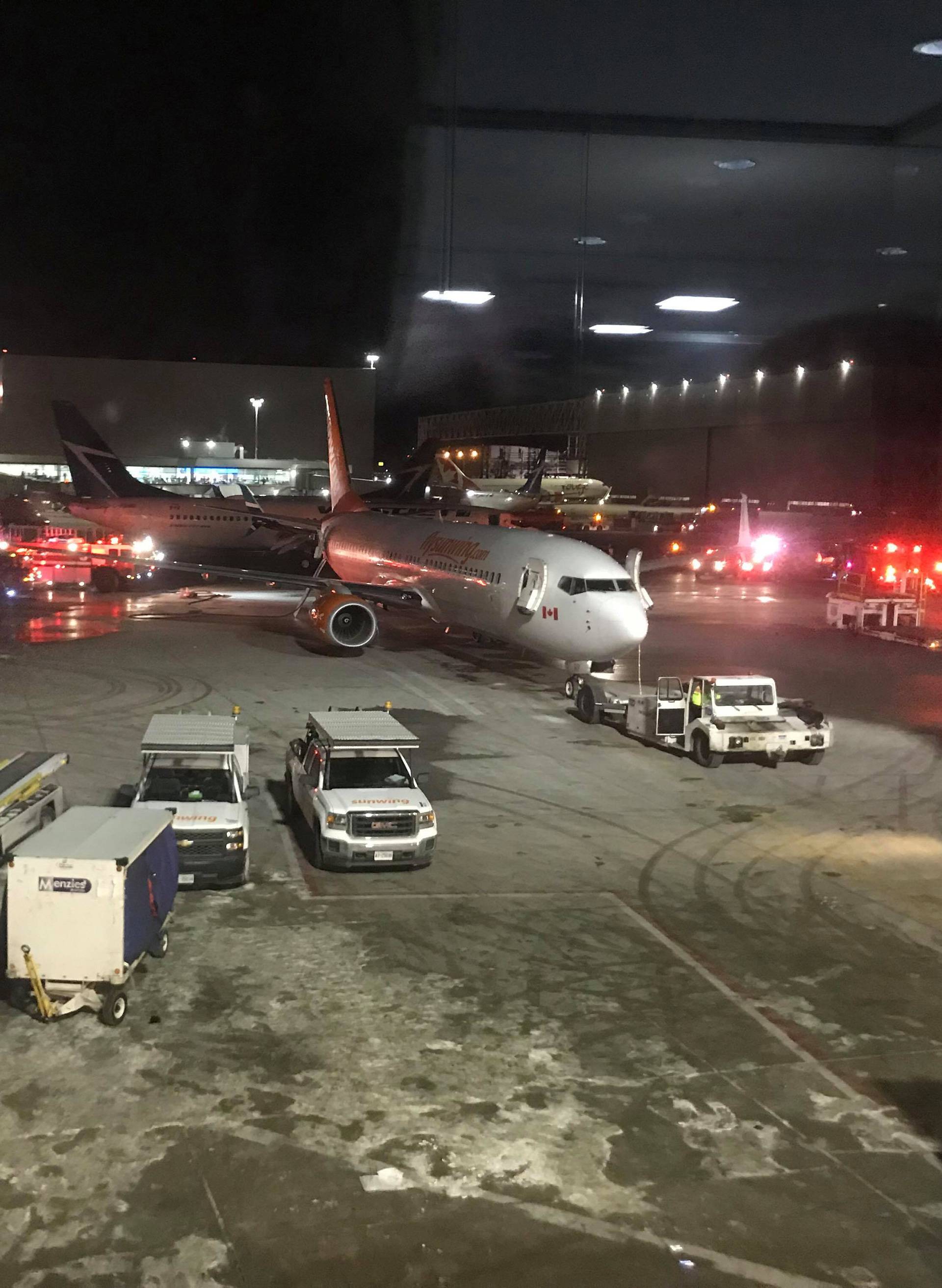 Emergency services arrive at a site where two planes collided at Toronto's Pearson Airport