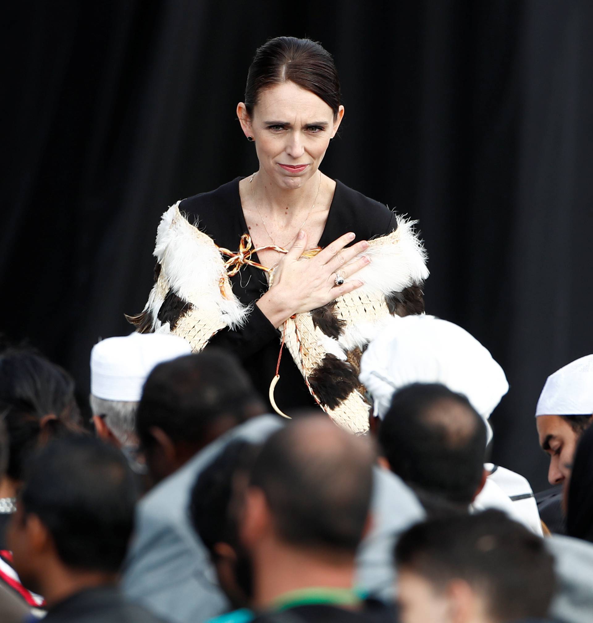 New Zealand's Prime Minister Jacinda Arden gestures to relatives of victims of the mosque attacks during the national remembrance service in Christchurch