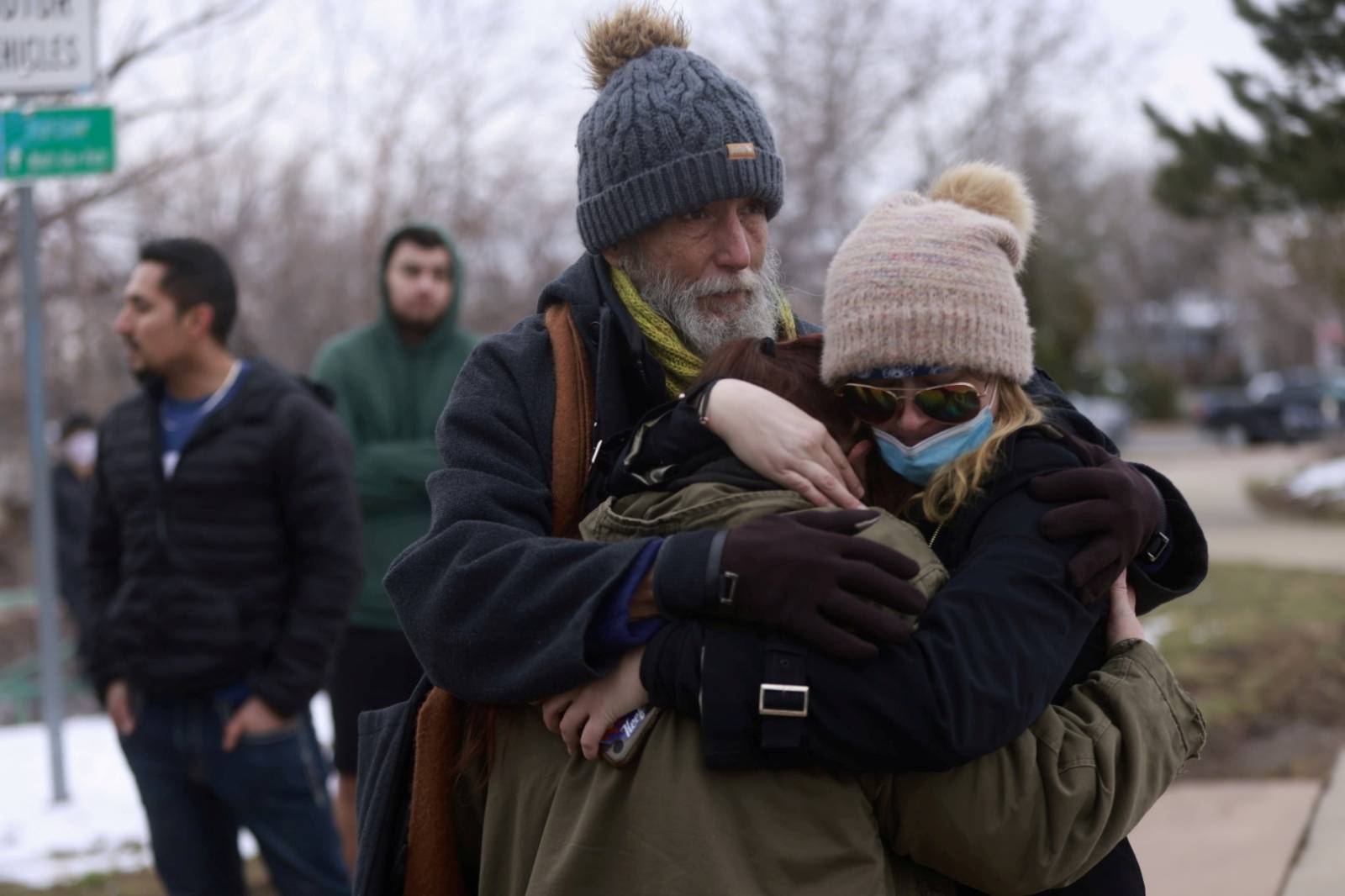 Sarah Moonshadow is comforted by David and Maggie Prowell after Moonshadow was inside King Soopers grocery store during a shooting in Boulder