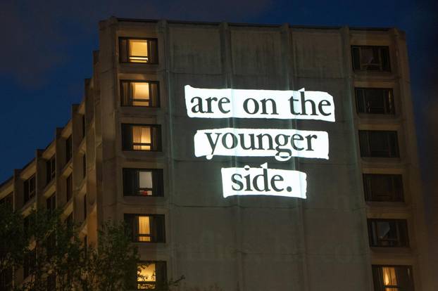 Documents and photos of Jeffrey Epstein and U.S. President Trump projected onto Hilton ahead of WHCA Gala, in Washington, D.C.