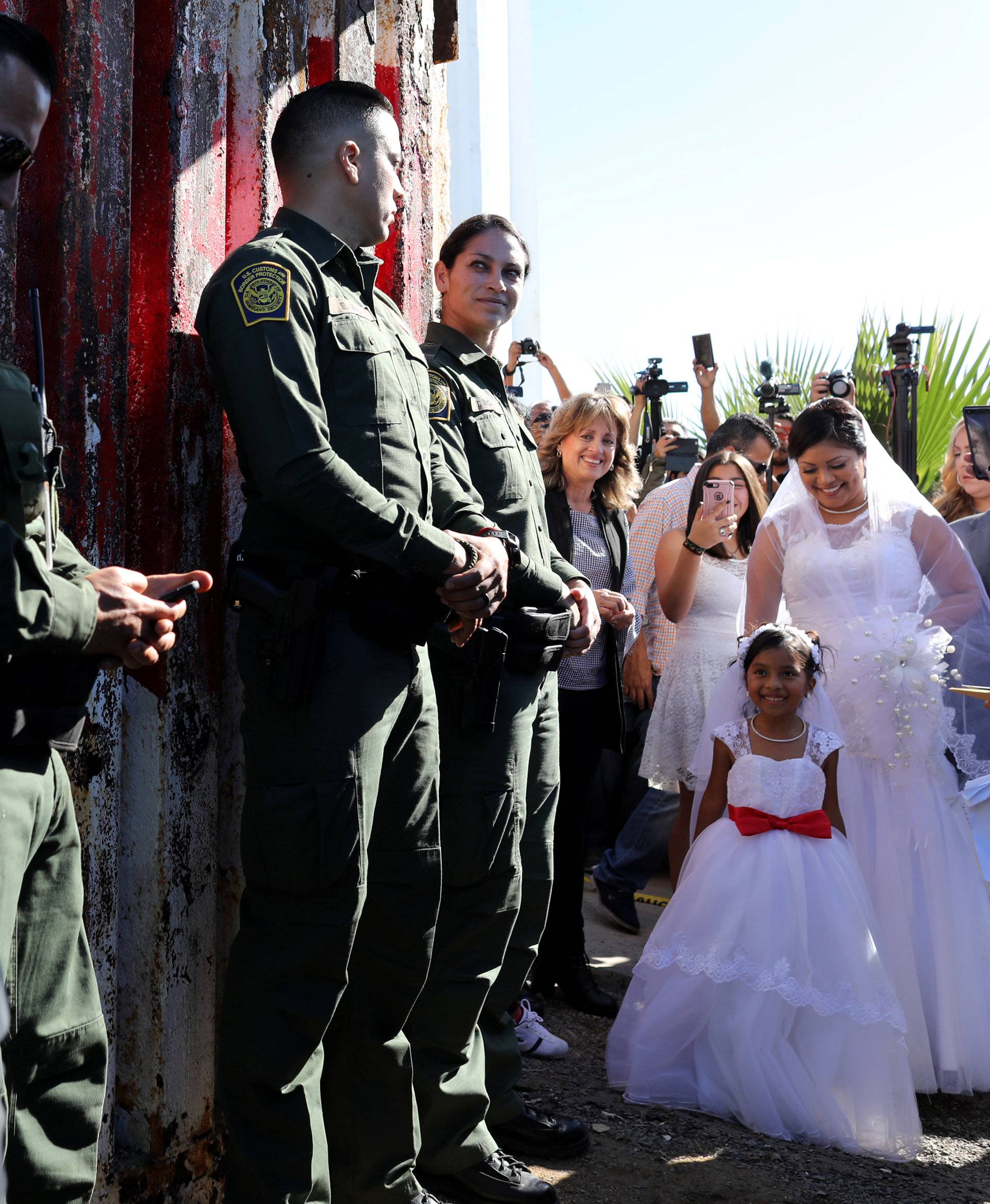 U.S. resident Brian Houston arrives to marry Evelia Reyes as Reyes' daughter Alexis looks on when U.S. Border patrol agents opened a single gate in the border wall to allow selected families short visits visit along the U.S. Mexico border in San Diego