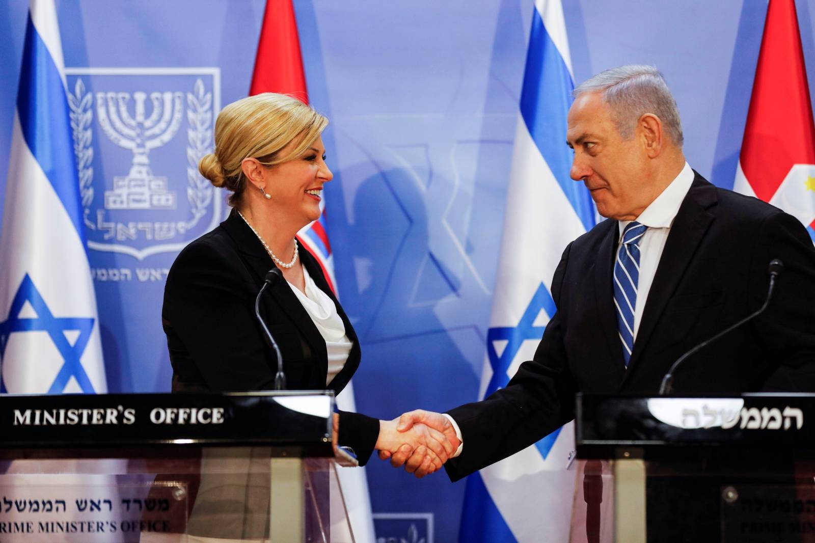 Israeli Prime Minister Benjamin Netanyahu shakes hands with Croatia's President Kolinda Grabar-Kitarovic as they hold a joint news conference in Jerusalem