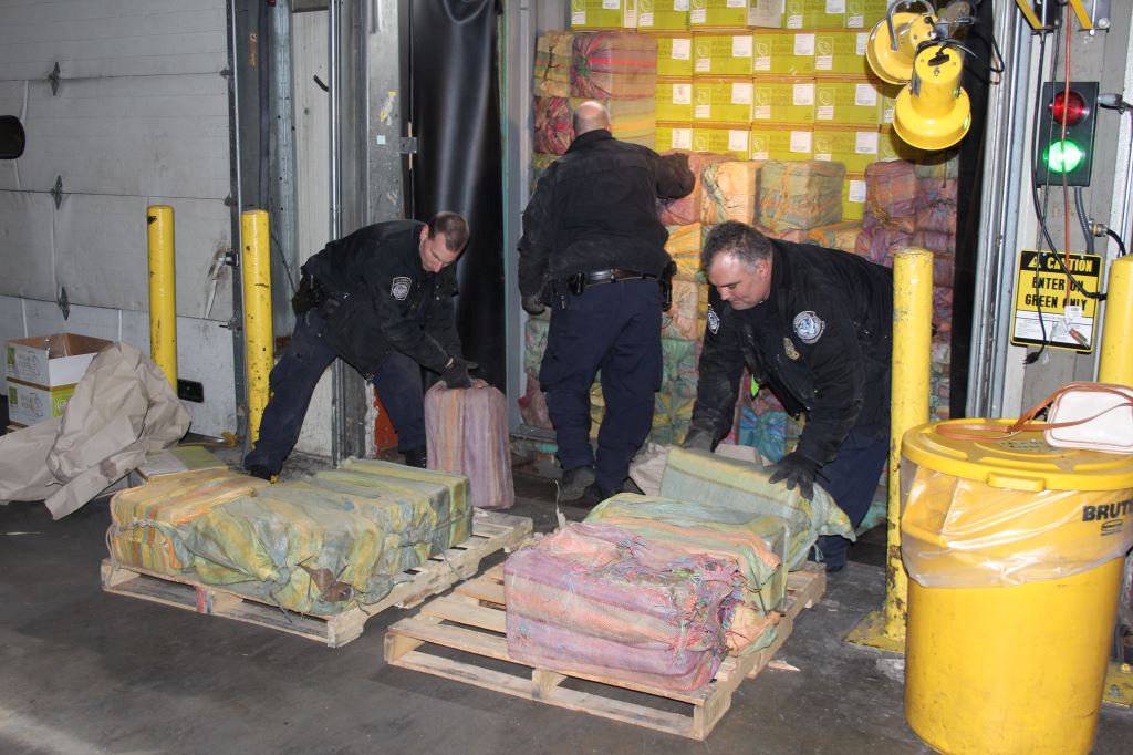 Law enforcement officers unload cocaine seized at the Port of New York/Newark