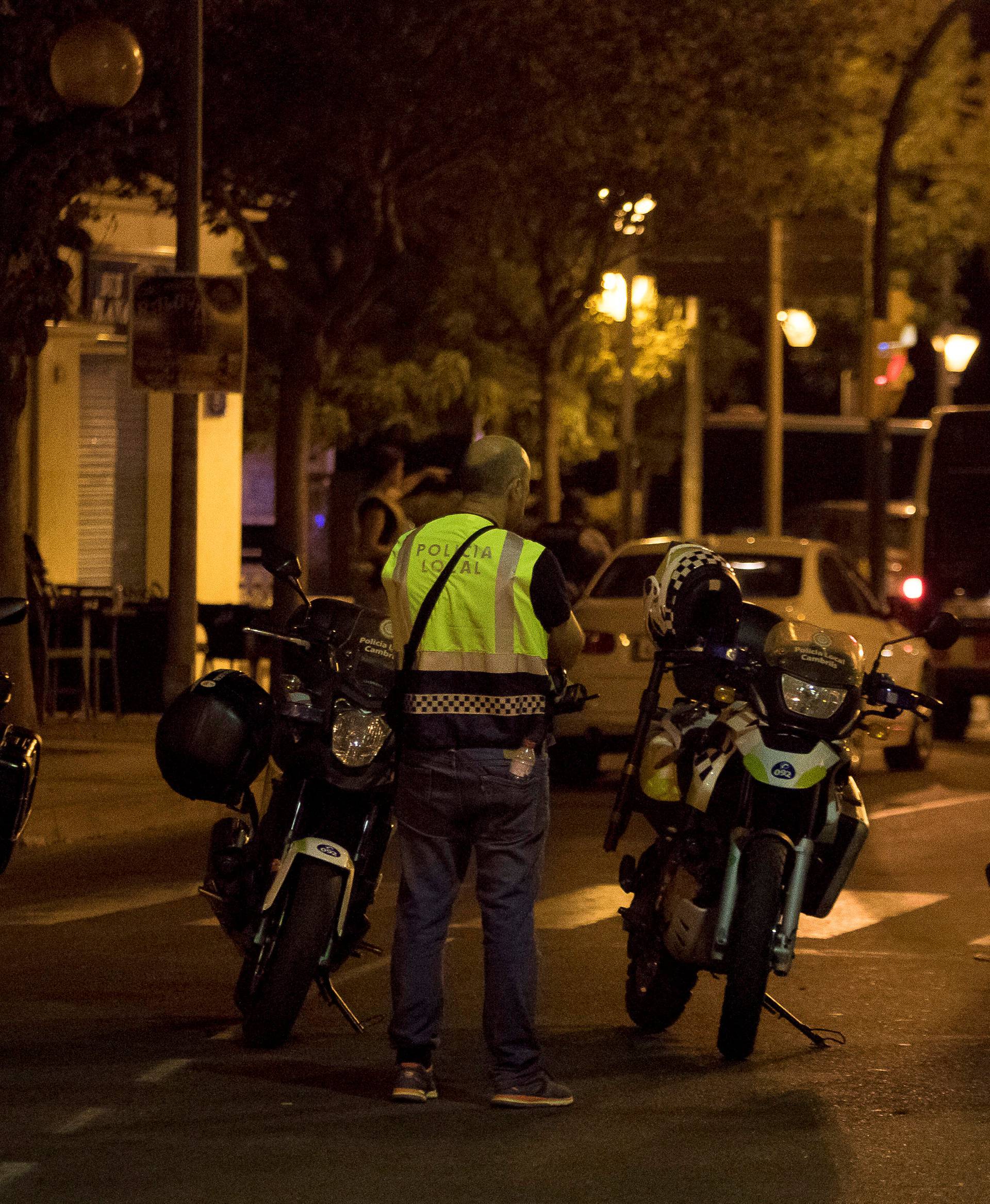 A police officer stands near the scene where police had killed four attackers in Cambrils, south of Barcelona, Spain