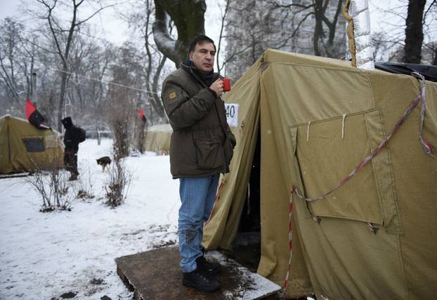 Former Georgian President Mikheil Saakashvili stands next to a tent set up in front of the Parliament building in Kiev