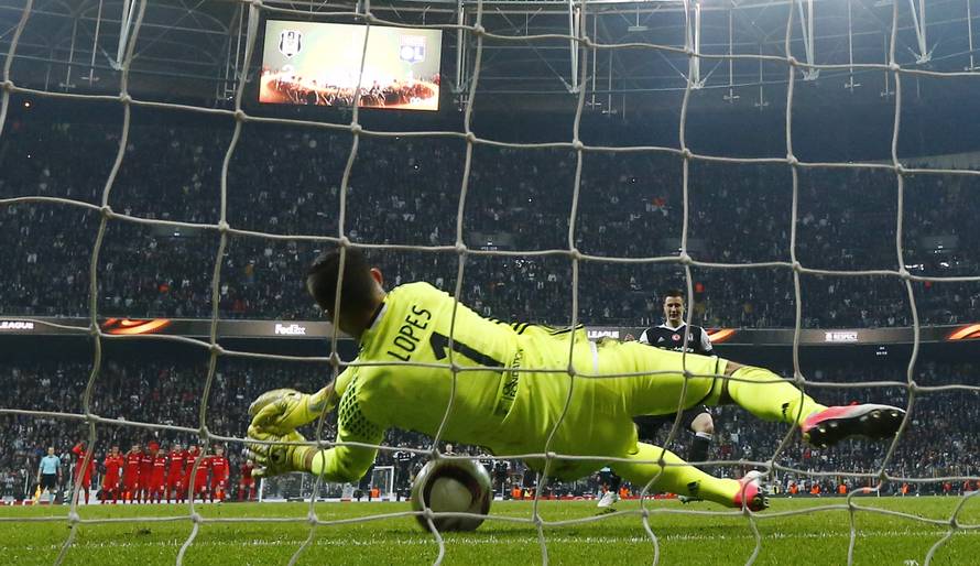Lyon's Anthony Lopes saves a penalty from Besiktas' Matej Mitrovic