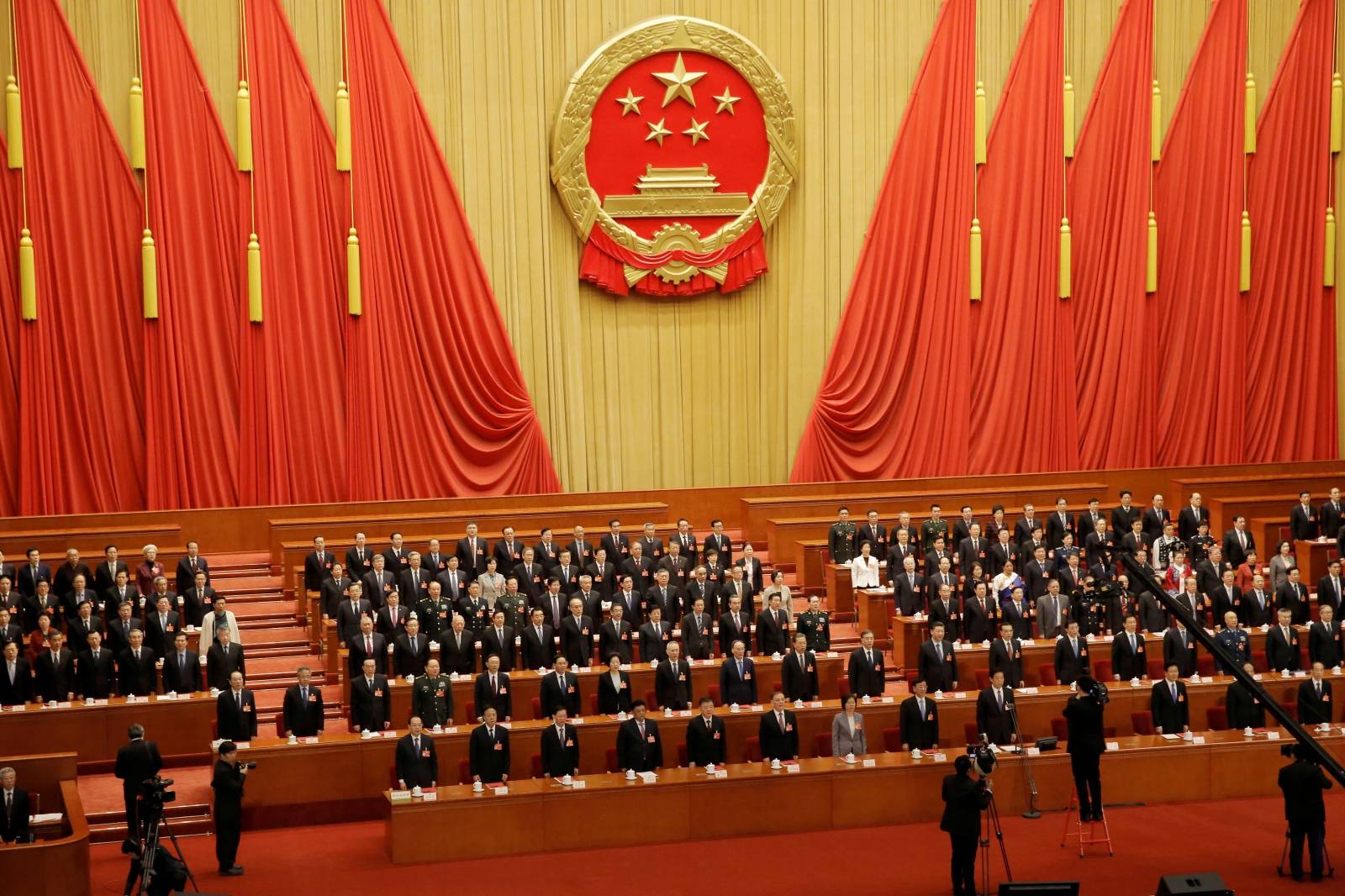 FILE PHOTO: File picture of officials singing the national anthem at last year's closing session of the National People's Congress