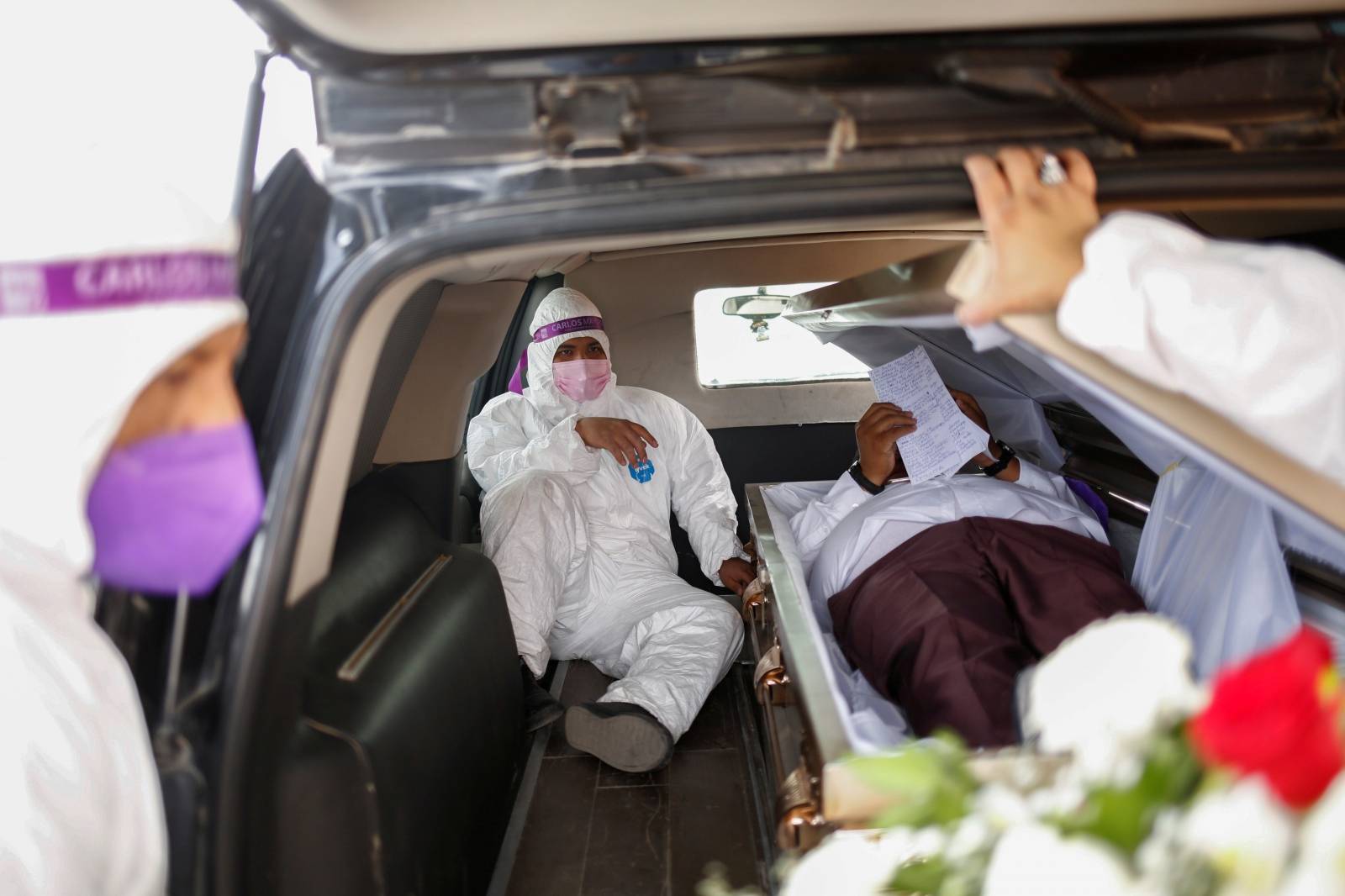 Carlos Mayorga, Mexican candidate for federal representative, lies in a coffin as part of his campaign slogan "If I don't deliver, let them bury me alive" near the Zaragoza-Ysleta international border bridge between Mexico and the U.S., in Ciudad Juarez