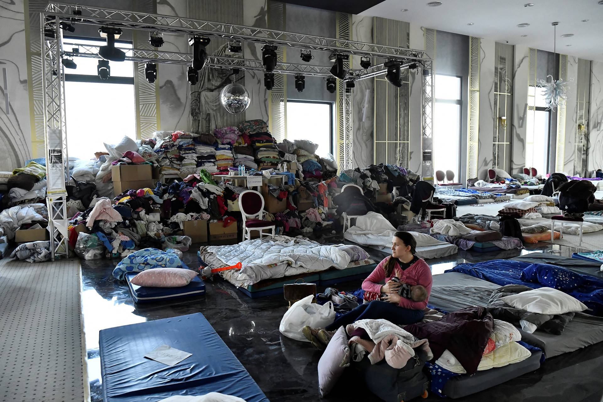 People fleeing Russia's invasion of Ukraine take refuge in a ballroom in a hotel in Suceava, in Romania