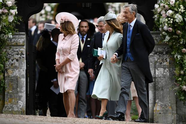 FILE PHOTO: FILE PHOTO: Carole Middleton and her husband Michael Middleton leave after attending the wedding of their daughter Pippa Middleton to James Matthews at St Mark