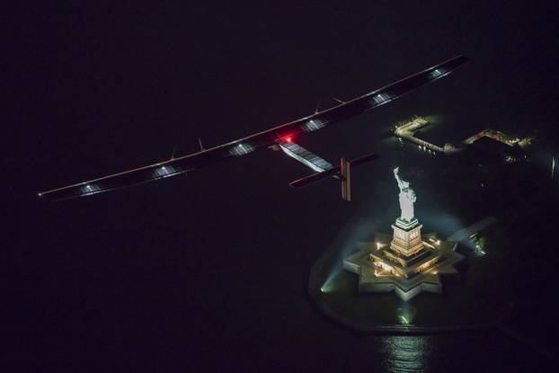 Solar Impulse 2, the solar airplane, piloted by Swiss adventurer Andre Borschberg, flies over the Statue of Libery in in New York, shortly before landing at John F. Kennedy airport