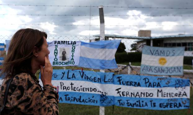 A woman looks at signs in support of the missing crew members of the ARA San Juan submarine in Mar del Plata