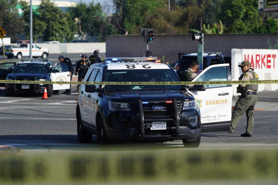 Police close off Alondra Boulevard due to a nearby protest against federal immigration sweeps, in Compton