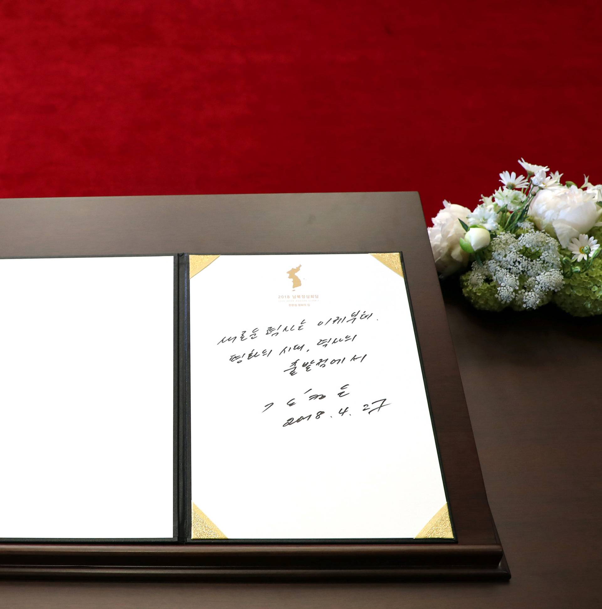 North Korean leader Kim Jong Un's entry in a guestbook is seen at the Peace House