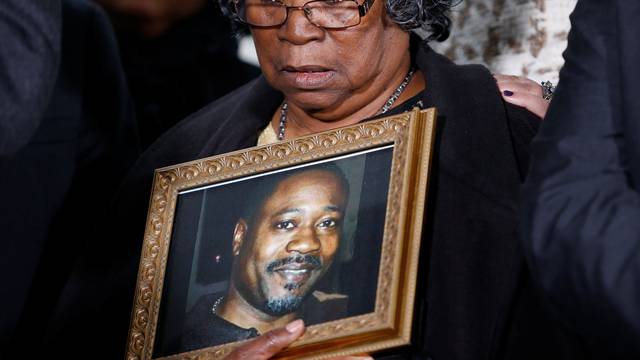Judy Scott looks over a photo of her son Walter Scott during a news conference after former police officer Michael Slager was sentenced to 20 years in prison, in Charleston