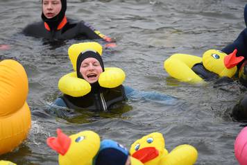 Swimmers wearing costumes bathe in the 3 degrees Celsius water of the river Danube during their annual 4 km swim, in Neuburg an der Donau