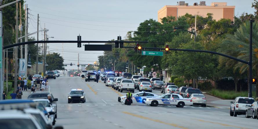 Police lock down Orange Avenue around Pulse nightclub, where people were killed by a gunman in a shooting rampage in Orlando