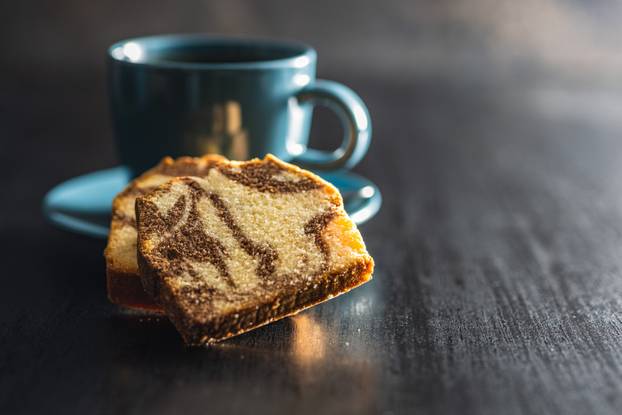Marble sponge cake and coffee cup. Cake with cocoa and vanilla taste.