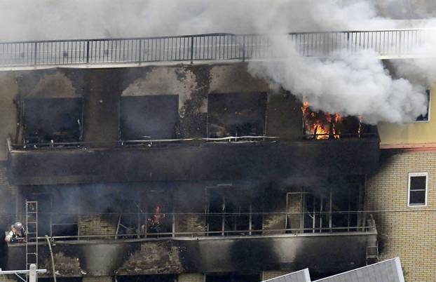 An aerial view shows smoke and flame rise from the three-story Kyoto Animation building which was torched in Kyoto