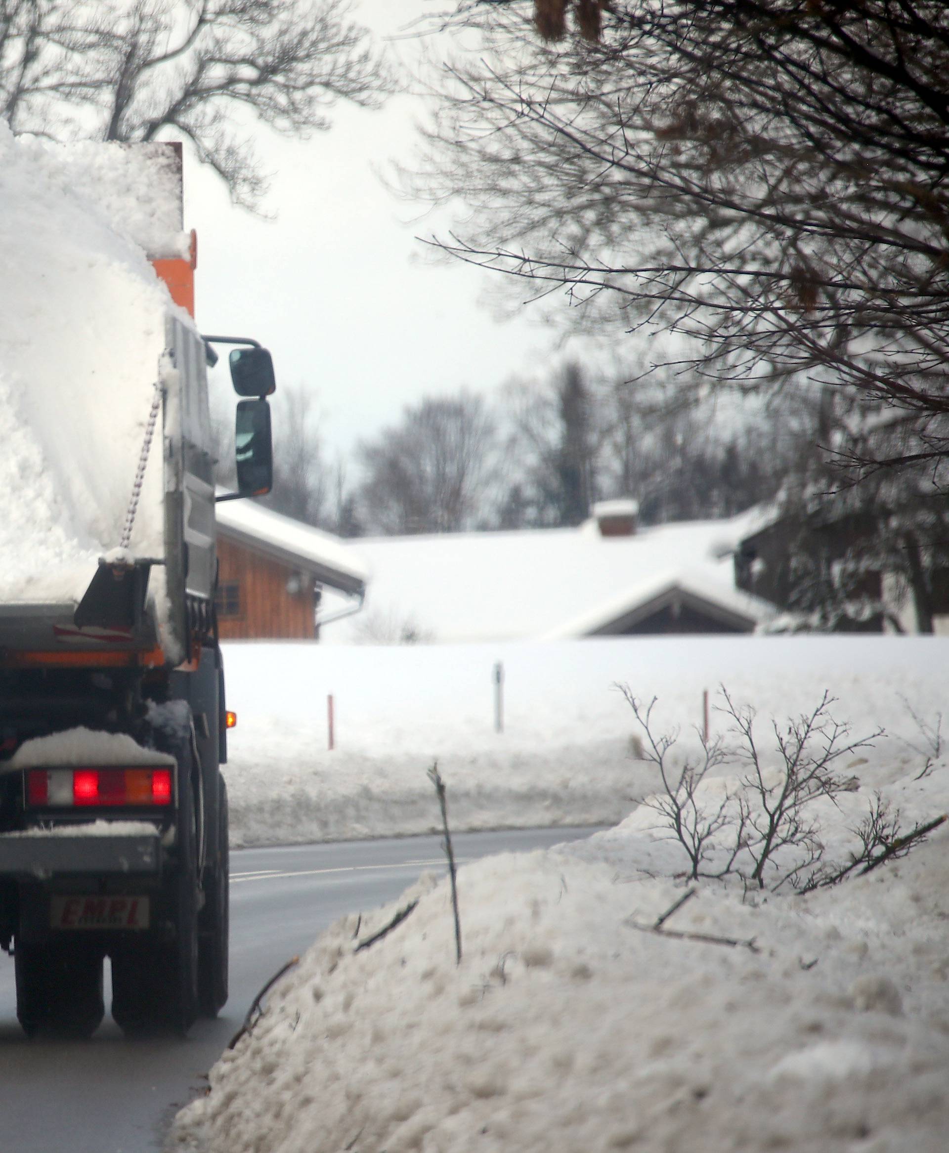 A truck carries snow near Miesbach, southern Germany