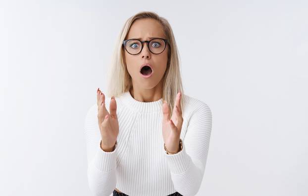 Woman worrying drunk friend drop fragile vase standing in stupor raising palms frowning and open mouth from shook and nervousness standing upset and anxious begging not make any move over white wall