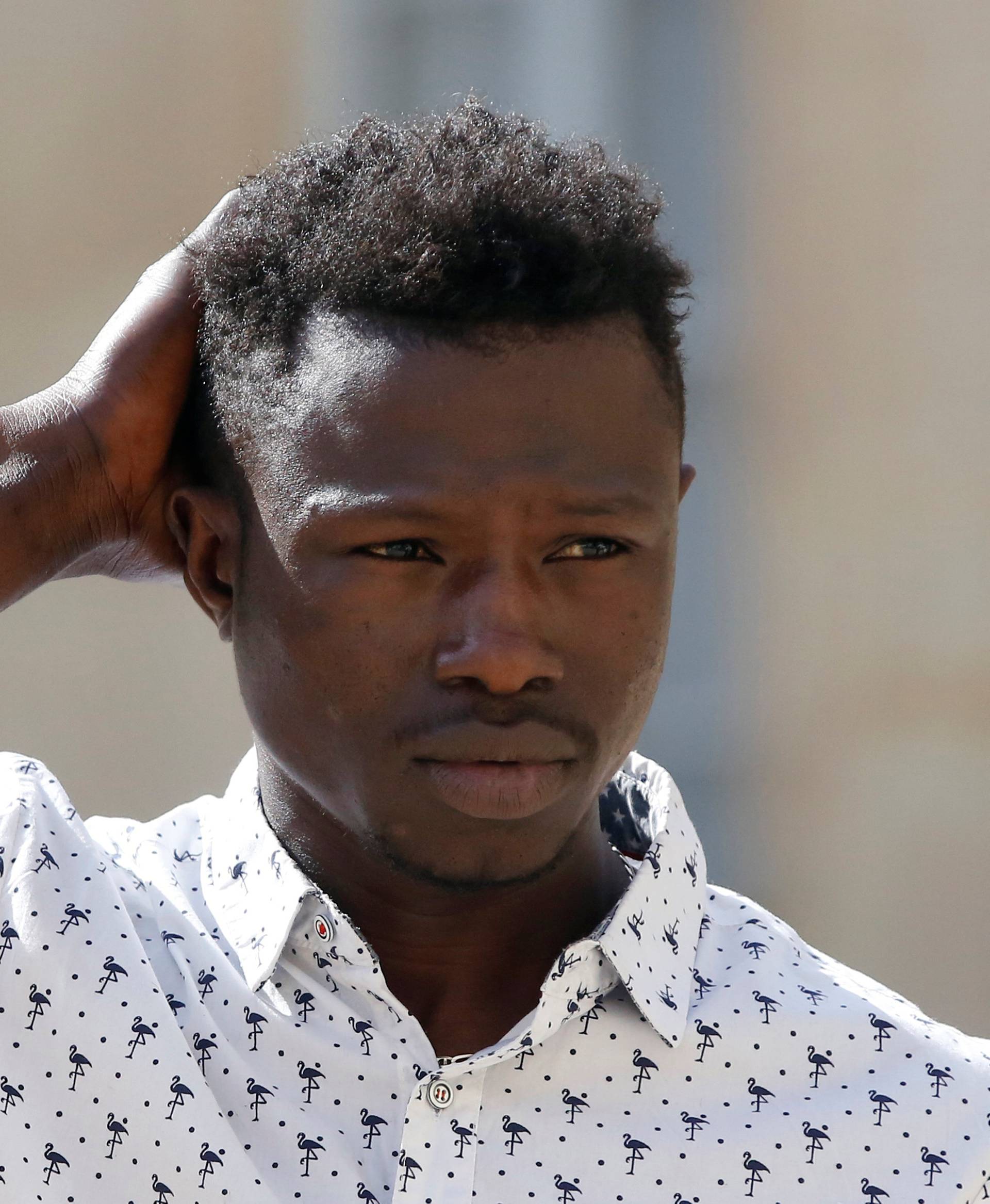 Mamoudou Gassama, 22, from Mali, leaves the Elysee Palace after his meeting with French President Emmanuel Macron, in Paris