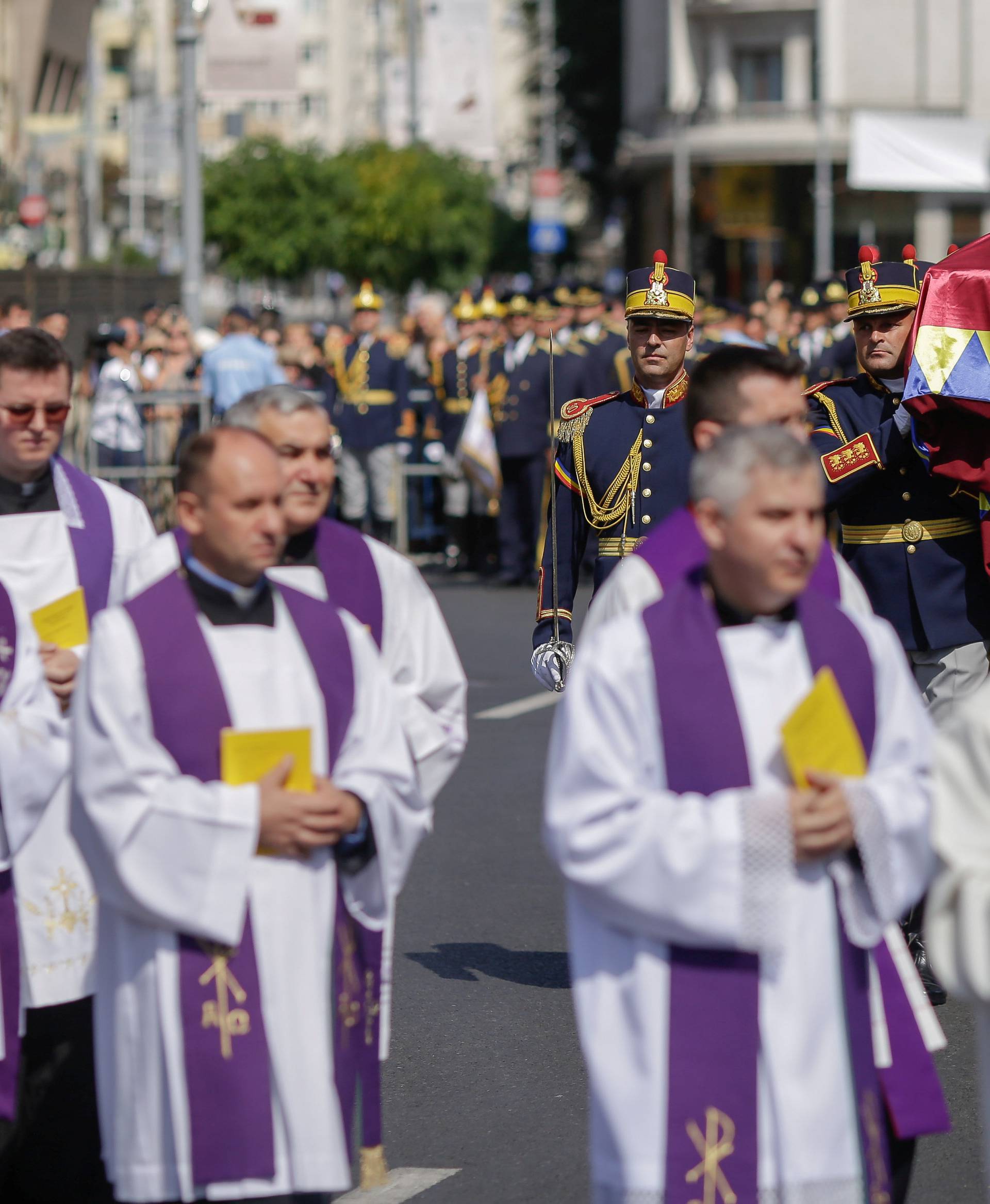 Romanian honor guard soldiers carry the coffin of the late Anne of Romania, wife of Romania's former King Michael, while arriving at a public religious ceremony in her honor in downtown Bucharest