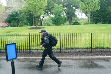 A U.S. Secret Service agent runs after alleged gunshots were heard nearby, at the White House in Washington