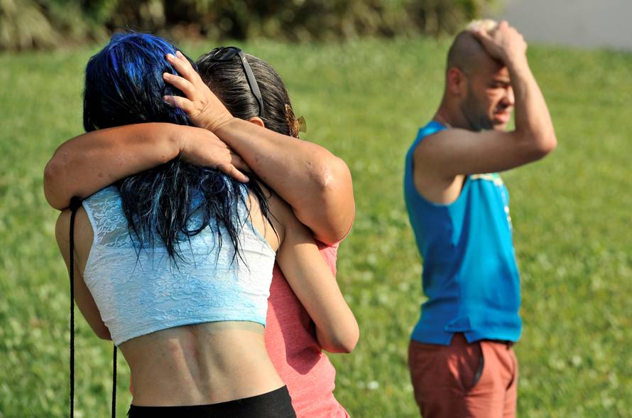 Friends and family members embrace outside the Orlando Police Headquarters during the investigation of a shooting at the Pulse nightclub, where people were killed by a gunman, in Orlando