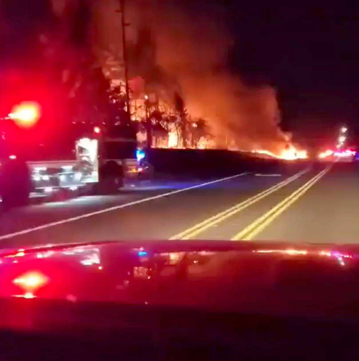 Vegetation is seen on fire along a side road in Molalla, Oregon