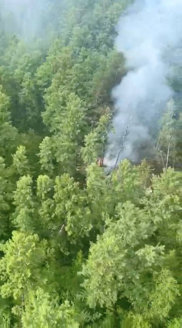 Smoke rises at the site of a plane crash in the Amur Region