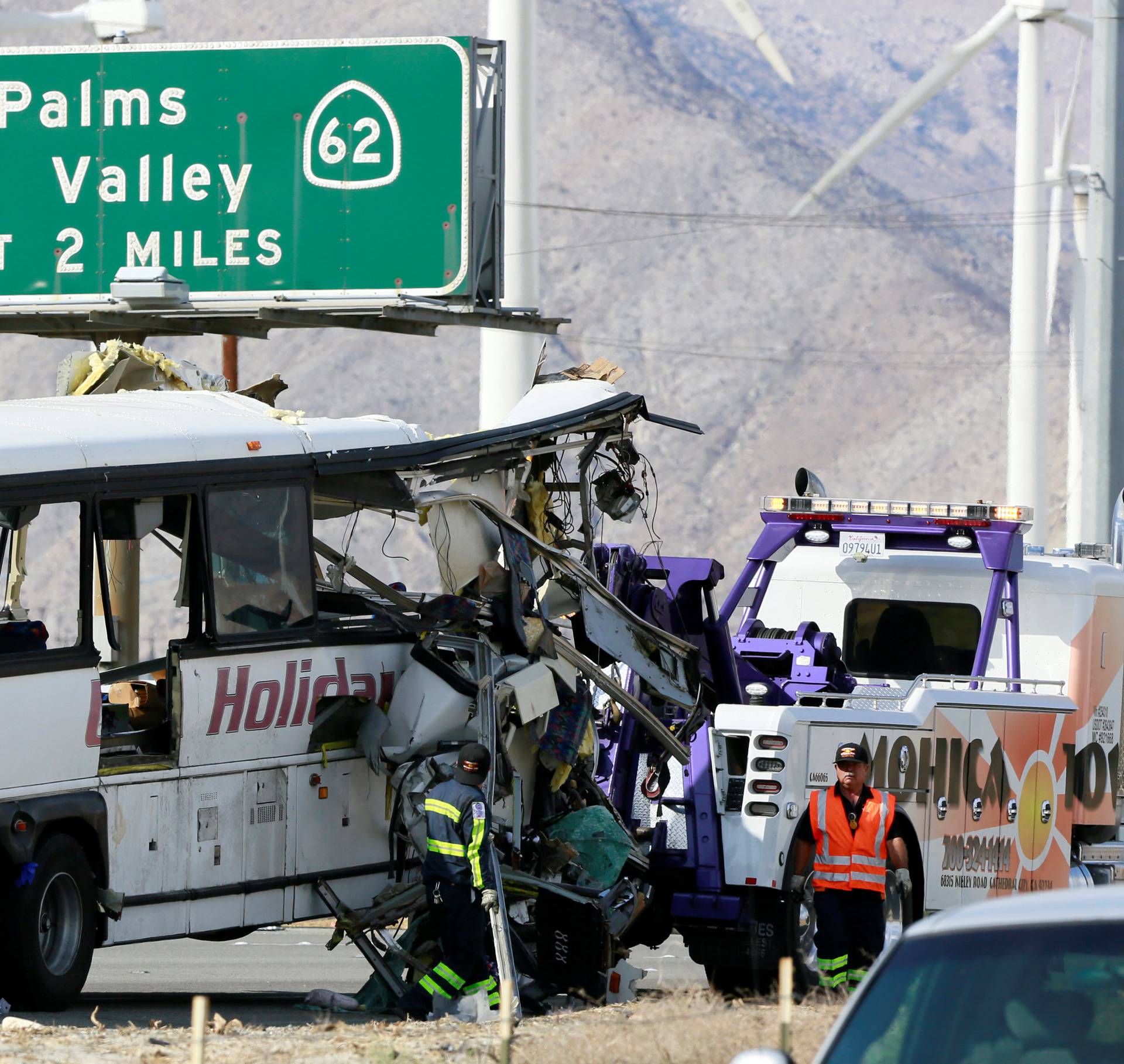 A mangled bus from the Holiday Bus Lines is seen after being towed from the scene of a mass casualty crash on the westbound Interstate 10 freeway near Palm Springs, California