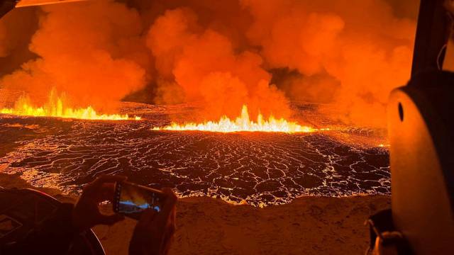 A volcano spews lava and smoke as it erupts near Grindavik