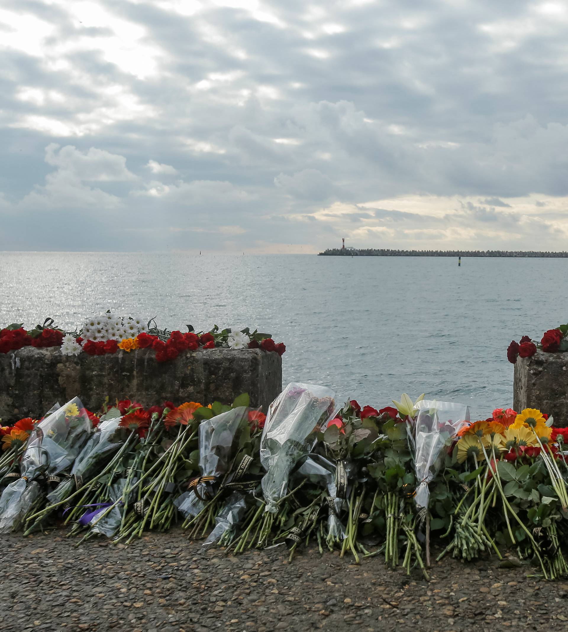 Flowers in memory of passengers and crew members of Russian military Tu-154, which crashed into the Black Sea on its way to Syria on Sunday, are placed at an embankment in the Black Sea resort city of Sochi