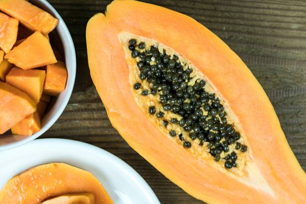 Papaya cut in half with pieces in bowl
