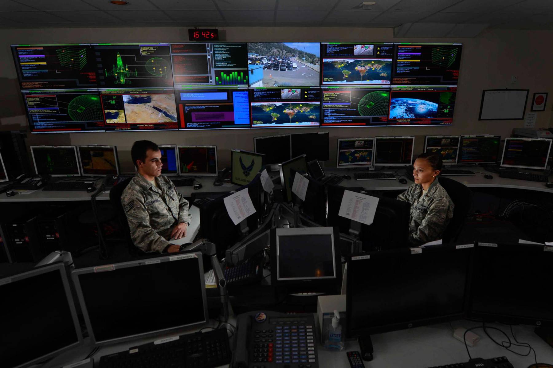 Staff Sgt. Alex Garviria and 2nd Lt. Rachel James work in the Global Strategic Warning and Space Surveillance System Center Sept. 2, 2014, at Cheyenne Mountain Air Force Station, Colo. Garviria is a 721st CS senior systems controller and James is the 721s
