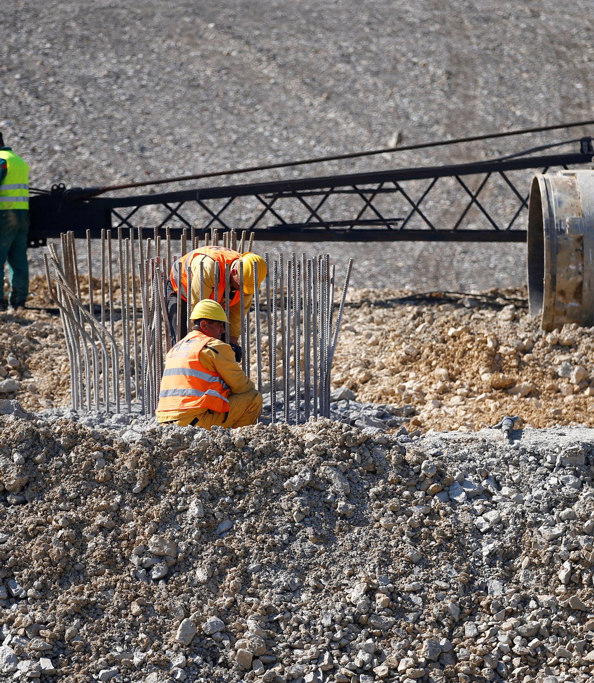 Men are seen at work at the EU-funded cross-border Svilaj bridge before its opening ceremony, in Donji Svilaj