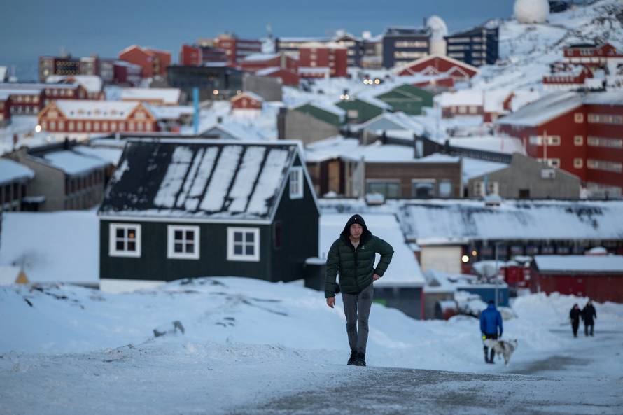 A man walks along a road on the day of the meeting between top U.S. officials and the foreign ministers of Denmark and Greenland, in Nuuk