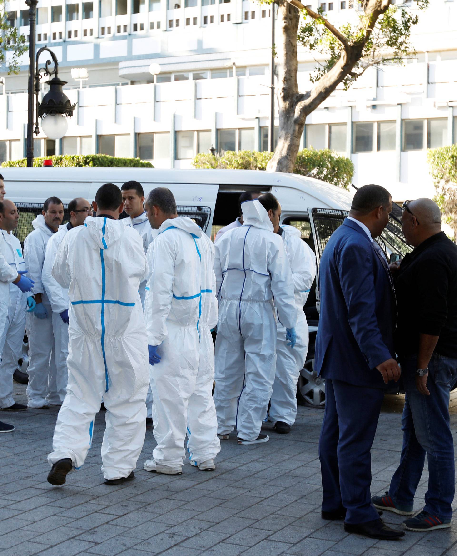 Forensic experts work near the site of an explosion in the center of the Tunisian capital Tunis