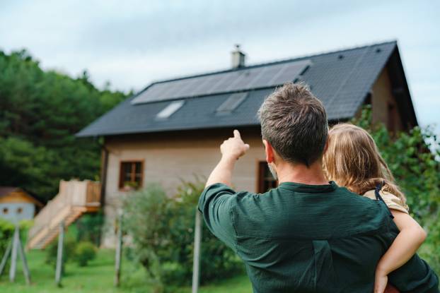 Rear,View,Of,Dad,Holding,Her,Little,Girl,In,Arms
