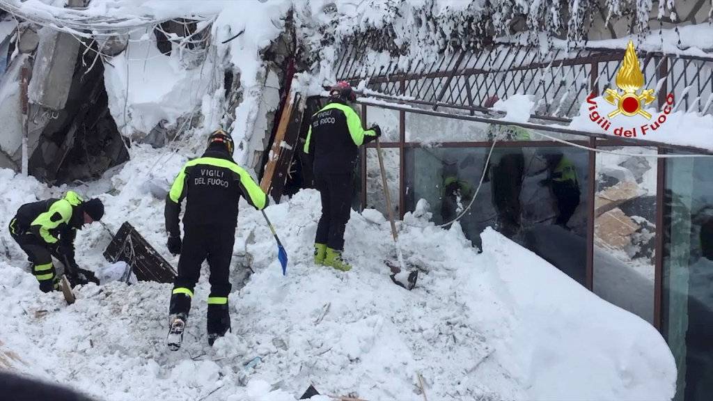 Firefighters work at Hotel Rigopiano in Farindola