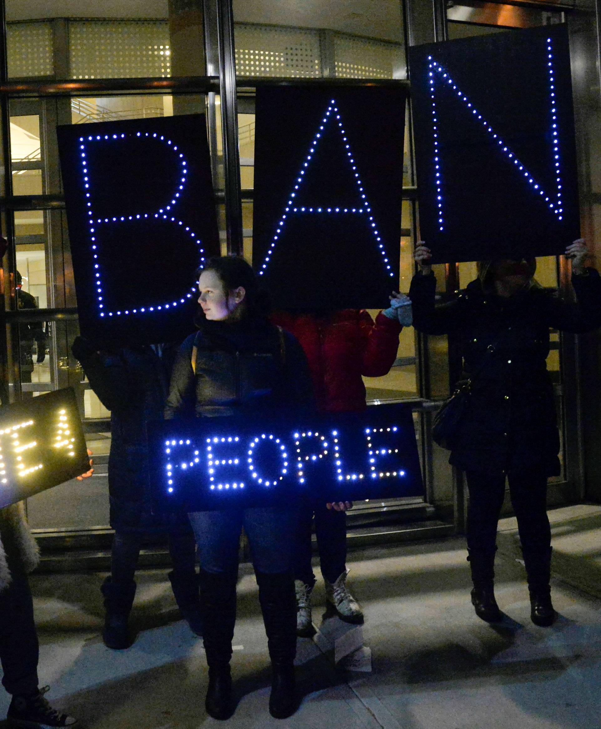 Activists hold placards outside a U.S. Courthouse in Brooklyn, New York